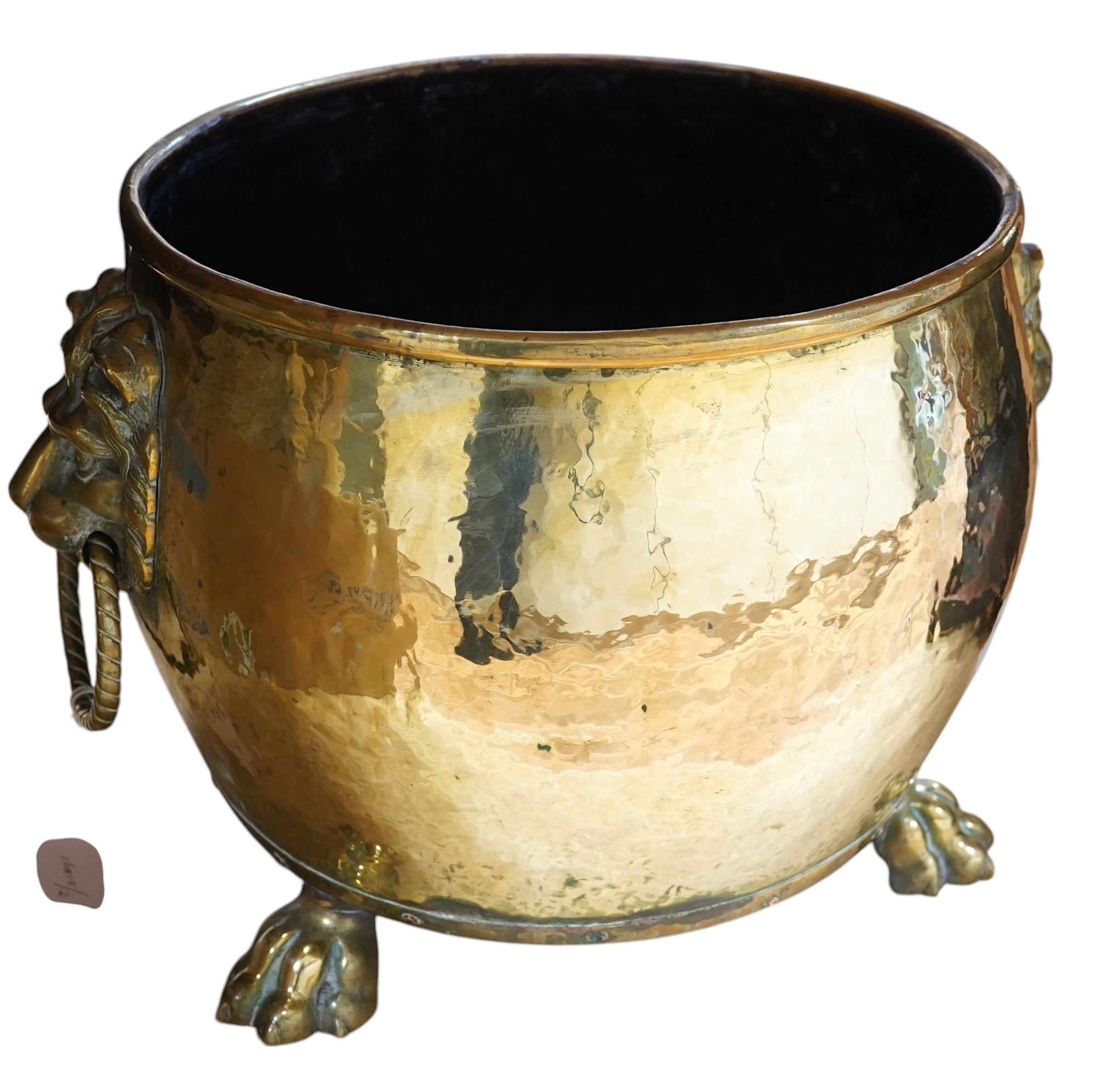 A large Victorian brass log bucket with lions head handles and paw feet, 50cm in diameter. Condition - fair to good